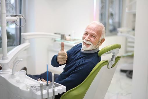 Senior man at a dentist's office. About 65 years old, Caucasian male.