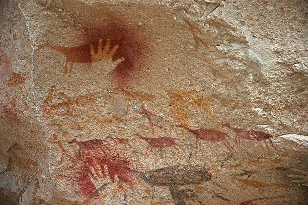 Prehistoric Cave Art Prehistoric human hand and animal paintings. cave painting photos stock pictures, royalty-free photos & images
