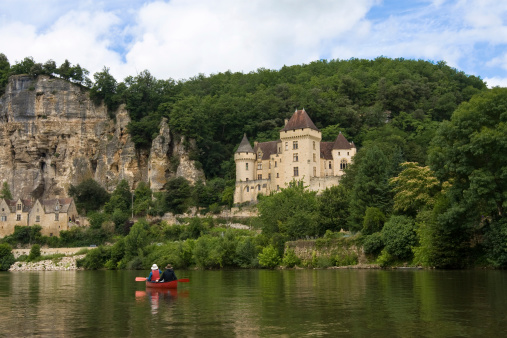Canoing on the idilic Dordogne River in France, past medieval castles and rock formations. 