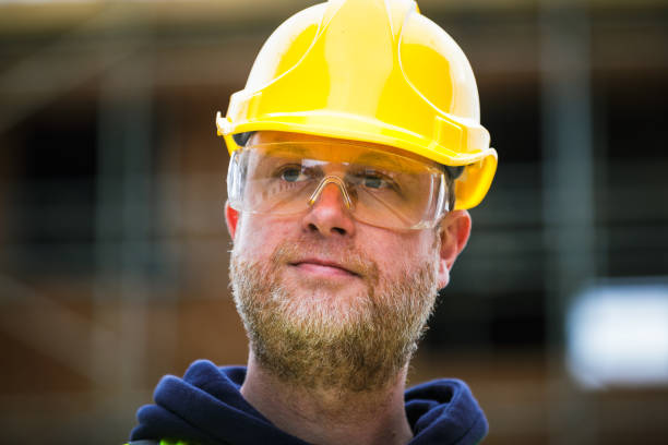 istock Portrait of construction worker in protective workwear on building site 1460542735
