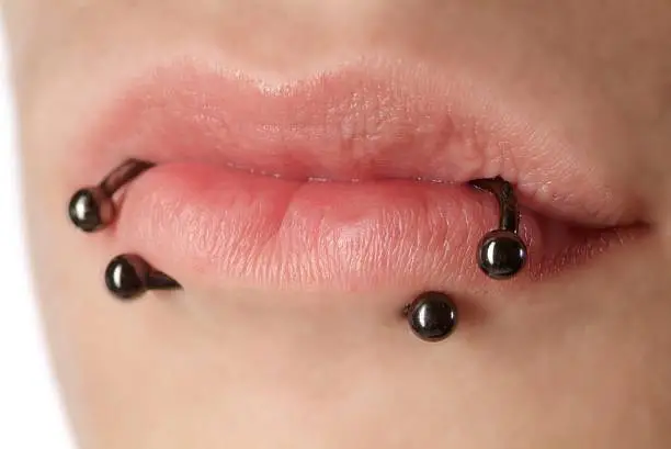 close up from a lip of a woman with piercing