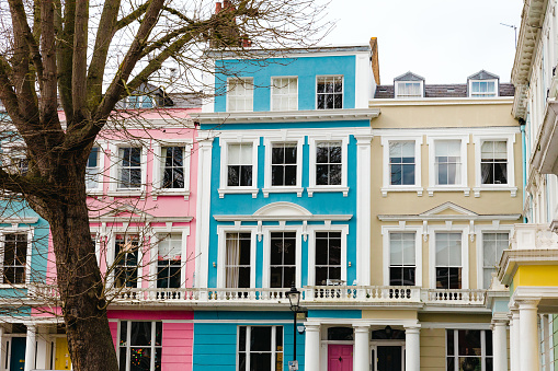 Vibrant pastel-coloured terraced townhouses on an exclusive London residential street in Primrose Hill, London.