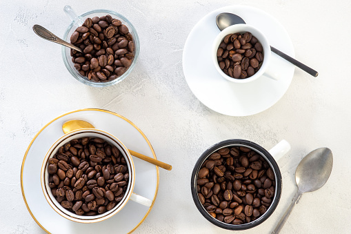 coffee, drink, beverage, four different coffee cups filled with organic coffee beans, top view and white background