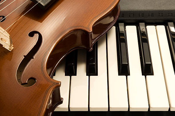 istock Violin laying on a Piano 146054934