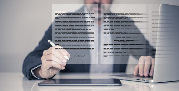 Man hand writing electronic signature on tablet virtual display. Sign contract, business agreement.