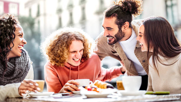 istock Happy couples drinking cappuccino at coffee bar patio - Young people talking and having fun together at sidewalk cafeteria - Life style concept with happy guys and girls at cafe dehor - Bright filter 1460550644