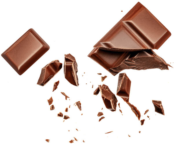 istock  Levitating milk chocolate chunks isolated on white background. Flying Chocolate pieces, shavings and cocoa crumbs Top view. Flat lay 1460551215