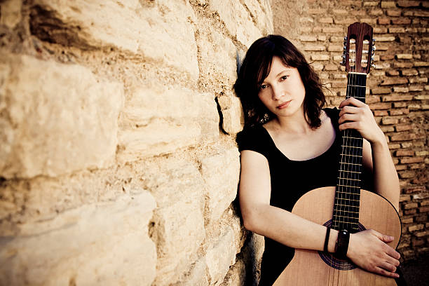 istock Street artist holding guitar 146055315