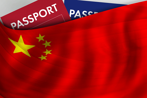 Chinese flag background and passport of China. Citizenship, official legal immigration, visa, business and travel concept.
