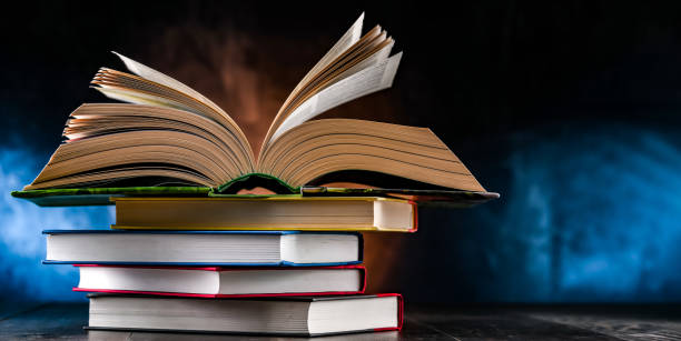 istock A composition with an open book lying on a stack of other books 1460554024
