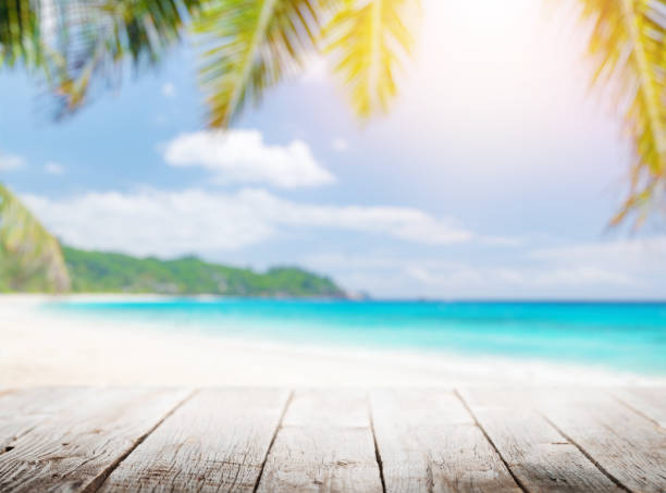 istock Empty wooden table or pier with sunny beach and sea 1460554556