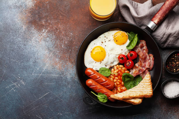 istock English breakfast with fried eggs, beans, bacon and sausages 1460554724