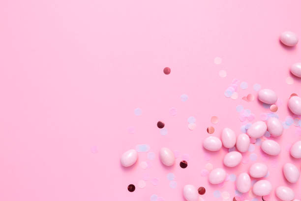 istock Bunch of candy eggs on pink background. Minimal Easter concept with copy space for text. Festive day backdrop. Flat lay style 1460560353
