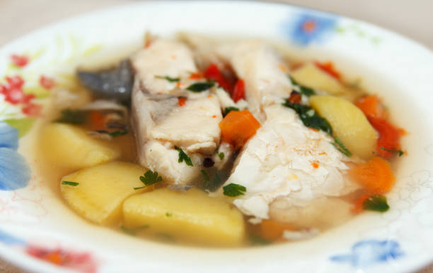 Fisherman's lunch. Lots of fish in soup with vegetables. Traditional dishes brewed outdoors stock photo