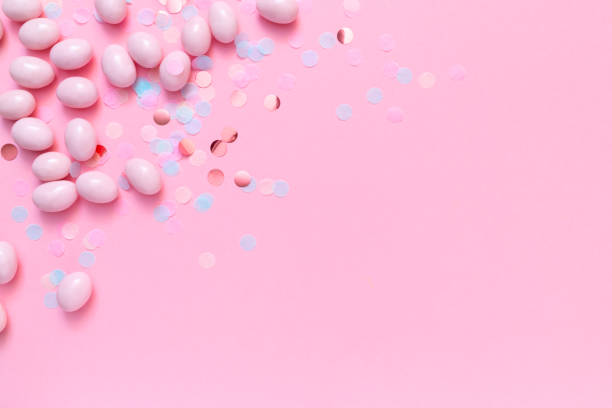 istock Bunch of candy eggs on pink background. Minimal Easter concept with copy space for text. Festive day backdrop. Flat lay style 1460560852