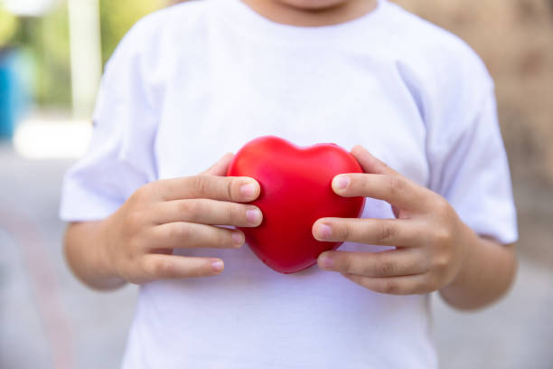 istock Child holding a heart in his hand 1460565288