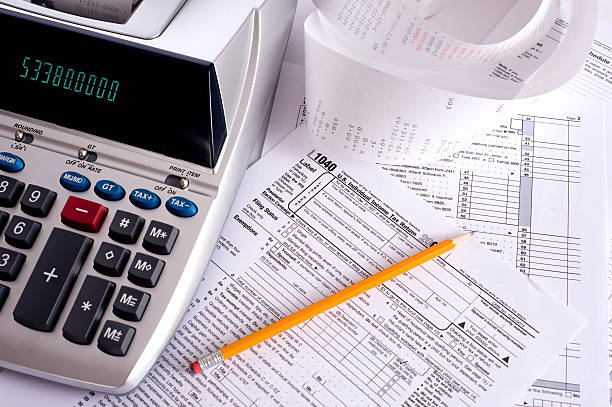 Adding Machine with tax forms stock photo