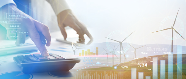 Energy prices calculating. Financial and economic growth on energy costs, businessman analyzing energy sales data and economic growth graph chart. Wind turbines with financial graph, analyzing data of power and energy prices, renewable energy sources, energy crisis