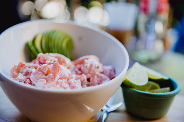 Seafood ceviche - king prawns, lemon, lime, juice, spring onions, chives and spicy chili red peppers. Traditional fresh dish from Peru, South America.