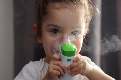 Little girl using nebulizer