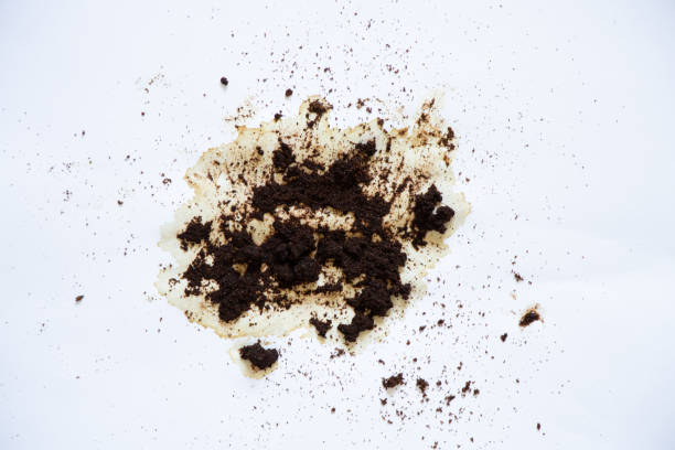 istock spilled coffee grounds on a white background and a teaspoon lies next to it, a coffee stain 1460568137