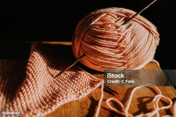 Closeup Of A Ball Of Pink Yarn Beside Knitting Stock Photo - Download Image Now - Art and Craft Equipment, Art and Craft Product, Backgrounds