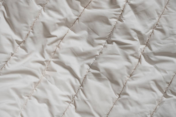 women's padded white soft jacket as background, of soft light fabric