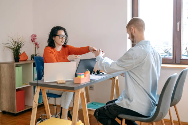 istock Young woman having client  in a small office 1460569985