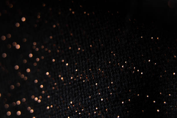 istock black fabric with shiny splashes in blurred focus, macro photo 1460570100