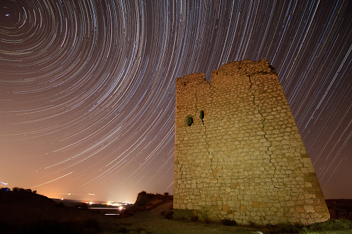 Aranjuez, Spain. August/13/2020 Star trails over the tower of the castle of Oreja, Aranjuez. Tower in the foreground with star trails. Circumpolar with clear skies. photograph taken in