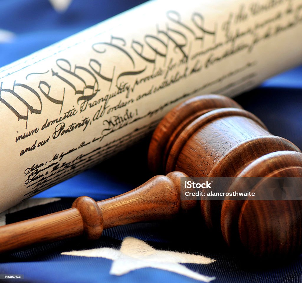 American Democracy Celebrating America's democratic government - gavel and constitution over flag background. People Stock Photo