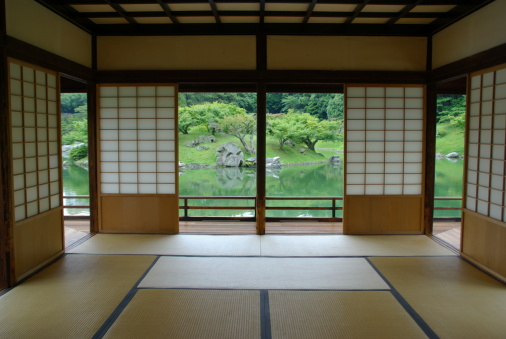 A traditional Japanese room with tatami, shoji, and garden view.