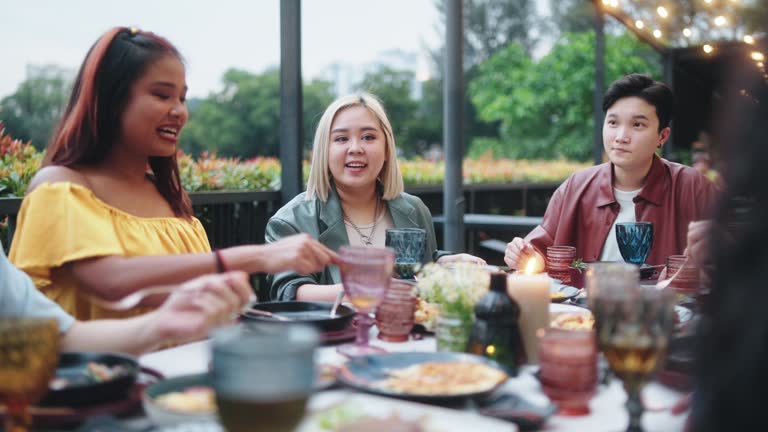 Outdoor Dining Asian Chinese  Friends  enjoying dinner together in the evening