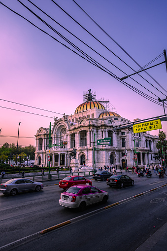 Mexico City, Mexico; January 25 2023: view to the palace of fine arts, sunset sky in mexico, violet colors.