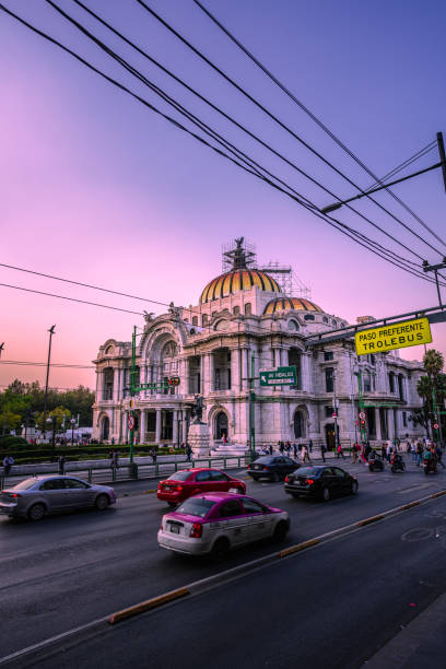 Fine Arts Sunset. Mexico City, Mexico; January 25 2023: view to the palace of fine arts, sunset sky in mexico, violet colors. song title stock pictures, royalty-free photos & images