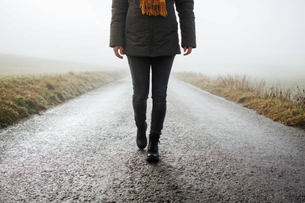 istock Lonely woman on empty road 1460580091