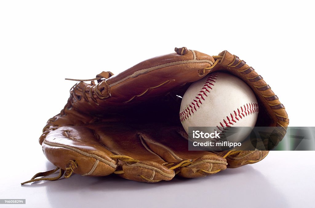 Baseball Glove and Ball a baseball and leather glove on a white background with a reflection in the table Baseball Glove Stock Photo