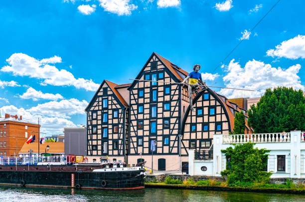 Bydgoszcz, Poland - June 30, 2022: Ancient medieval buildings of watermills and granaries in Bydgoszcz on the Brda river, Poland. Cityscape of the historical district in Bydgoszcz