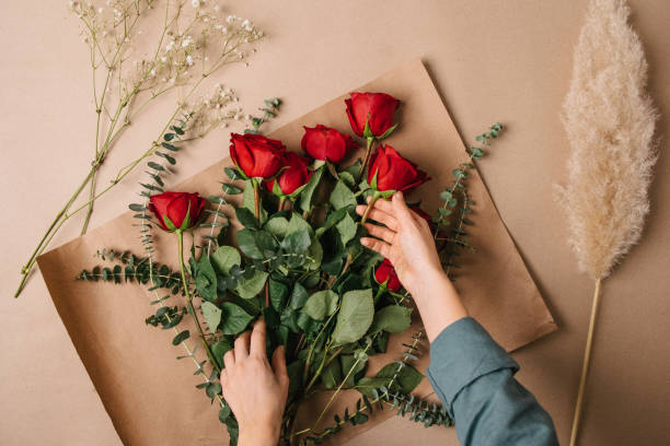 istock A woman making a bouquet with red roses 1460583687