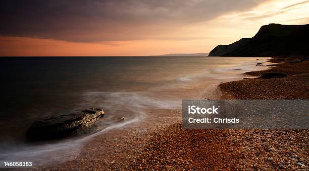 Eype Beach Sunset Stock Photo - Download Image Now - Back Lit, Beach, Blurred Motion