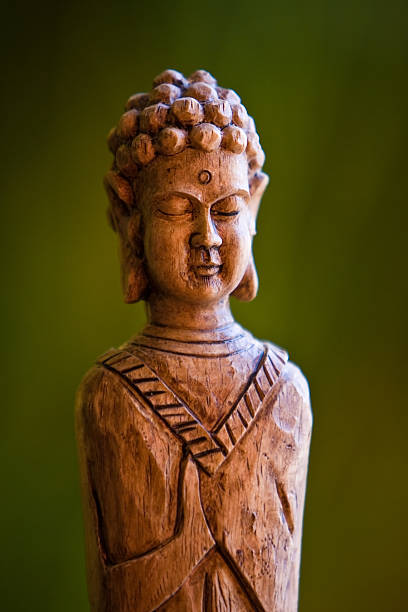 istock Wooden Buddha on Green Background 146058476
