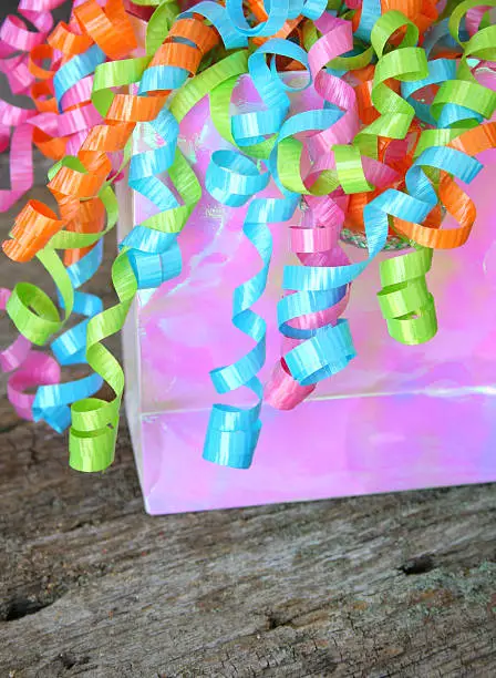 Gift bag with colorful and curly ribbons.