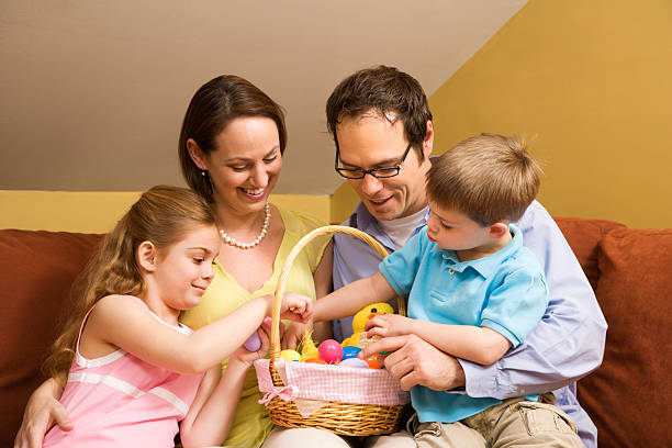 istock Parents with children looking through an Easter basket 146058615