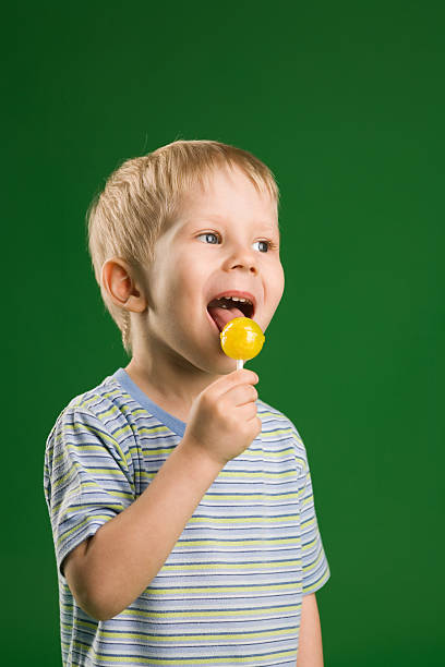 Boy with lollipop stock photo