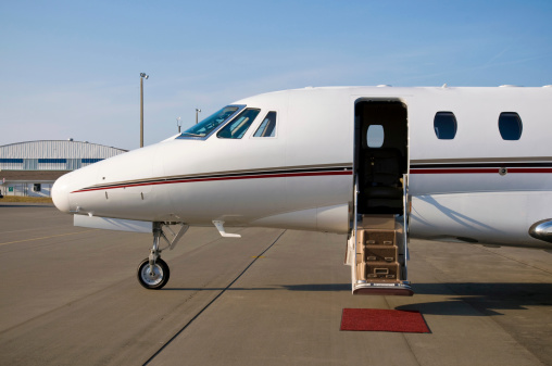 Corporate private jet at airport door open with blue sky background