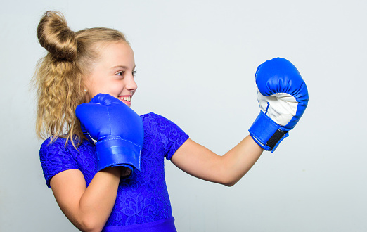 Sport and sportswear fashion. training with coach. Fight. Boxer child workout, healthy fitness. knockout and energy. Sport success. little girl in boxing gloves punching.