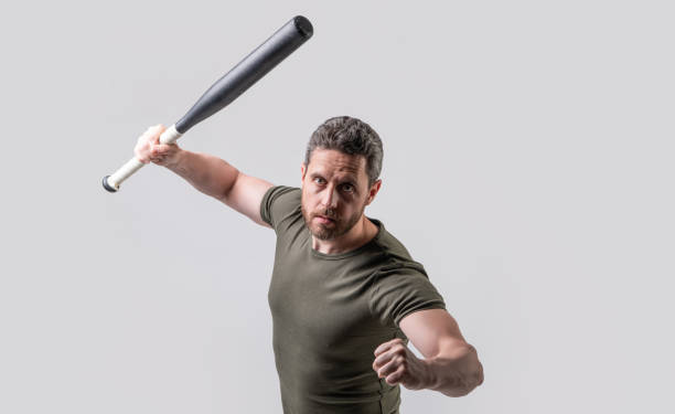 istock man express aggression beating with bat isolated on grey background. aggression of man 1460592366