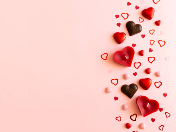 istock Pink valentines day background with different hearts - chocolate, candles, confetti 1460592500