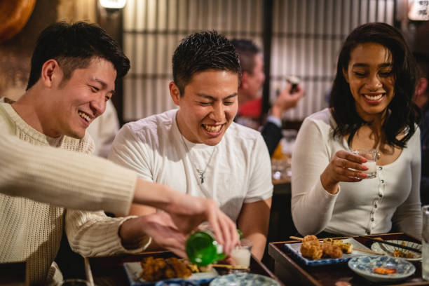istock Three Coworkers Having Fun At An Izakaya 1460592935