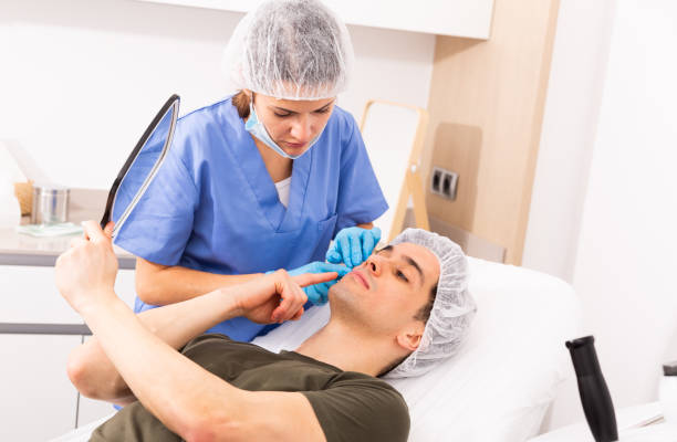 istock Woman cosmetologist examining male client face 1460593047